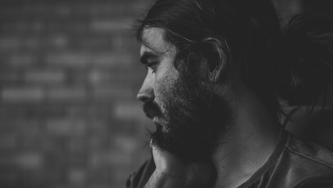 Portrait of a man with dark hair and beard