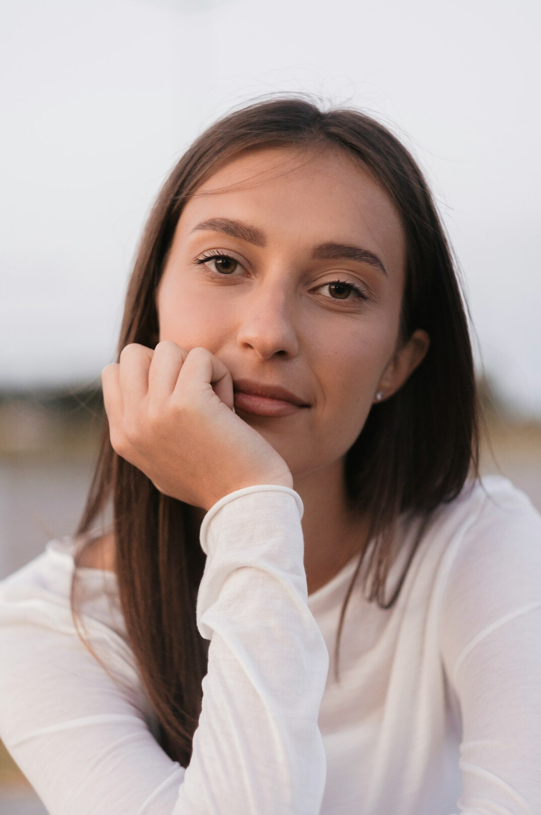 Smiling young woman portrait on light background
